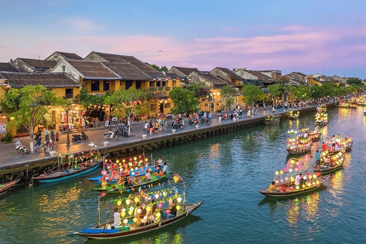 Lantern boats filling the Hoai River in Hoi An at twilight, seen from above