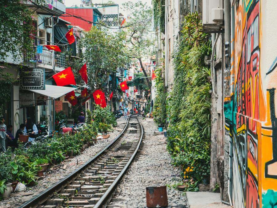 Lantern-lit cafés along Hanoi's famous train street at dusk